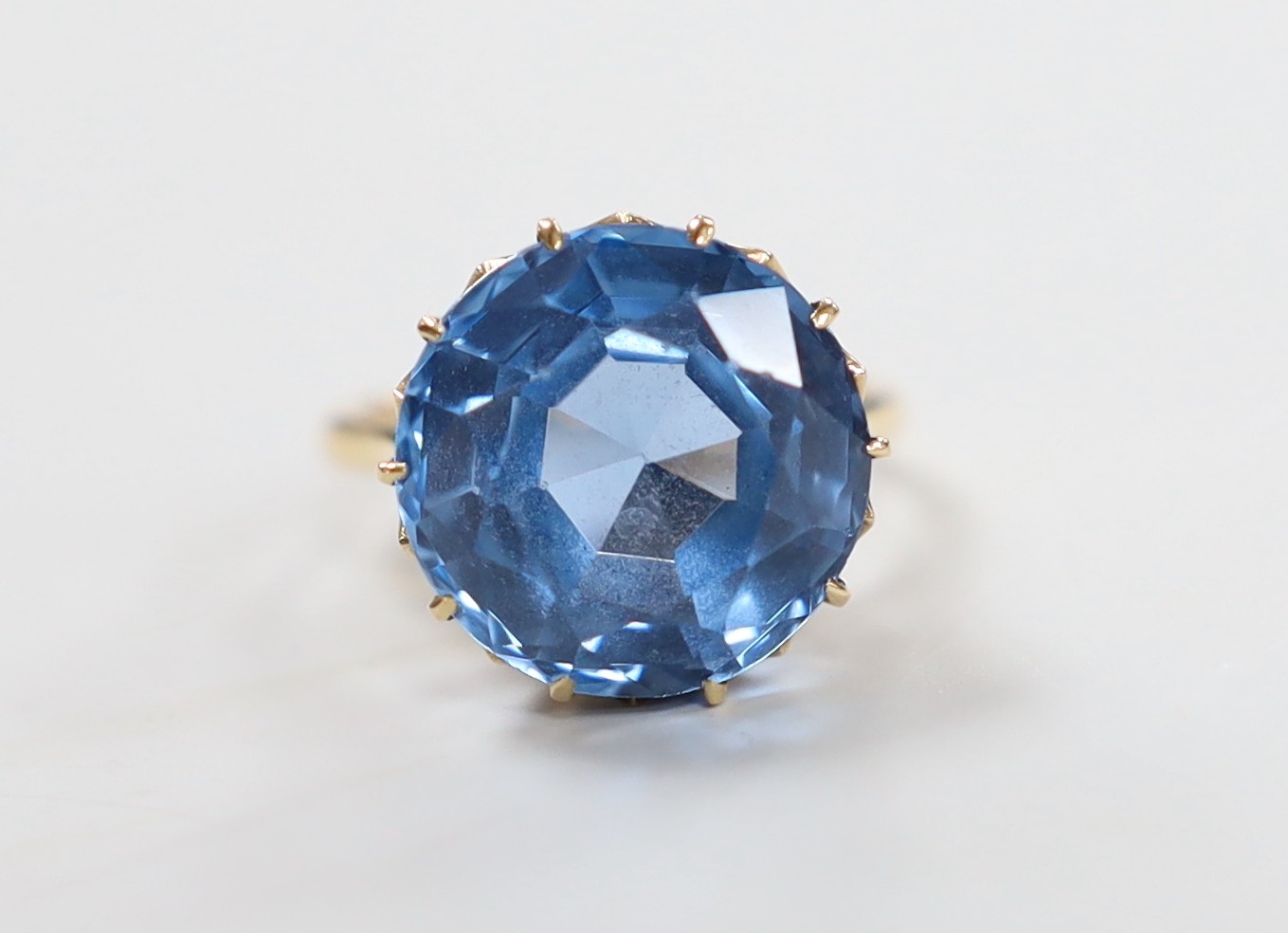 An 10k and blue paste? set ring, size K/L, gross weight 7 grams.